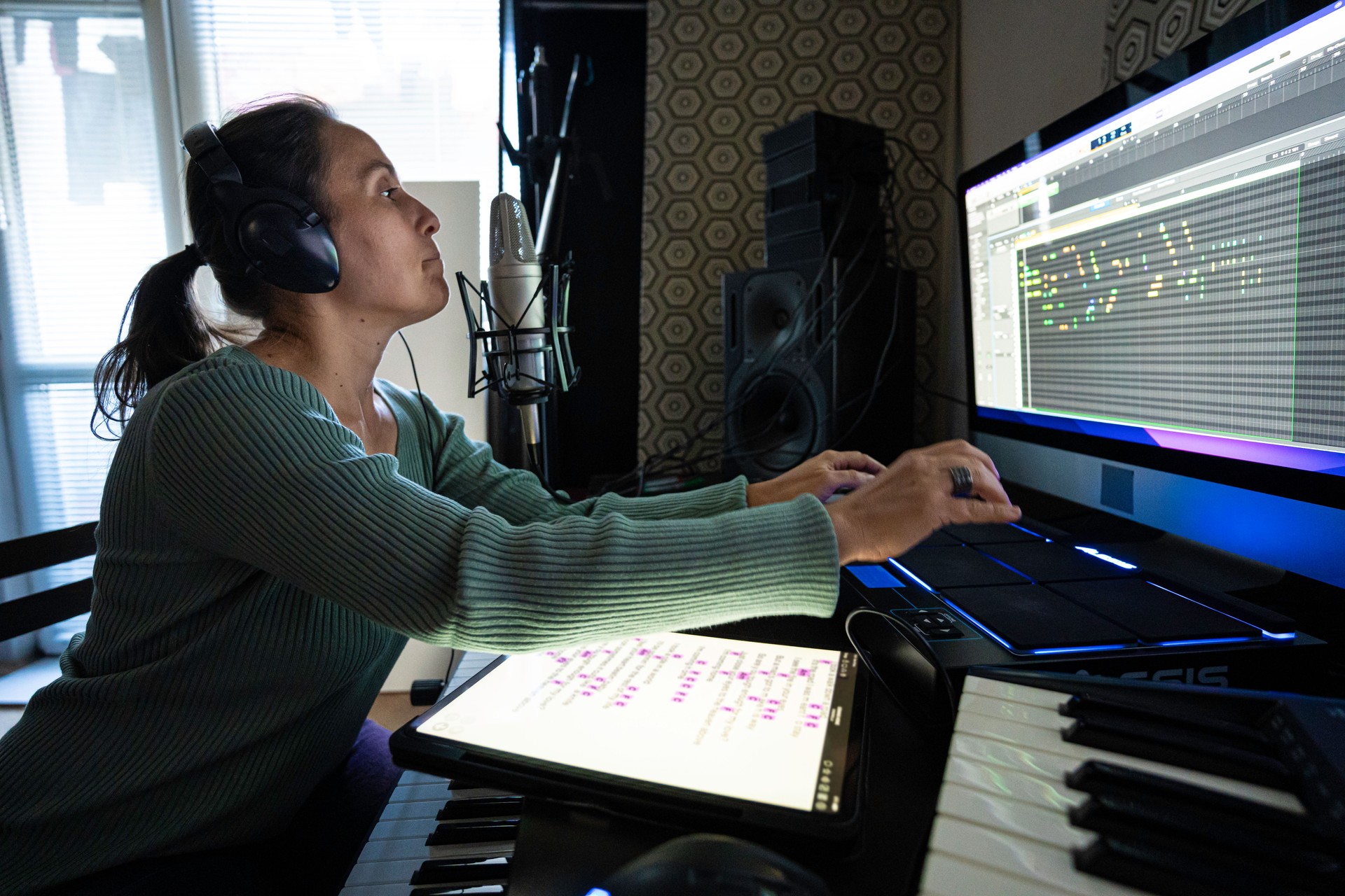 Woman Playing on MIDI Drum Pad Controller in Music Studio, Close-Up